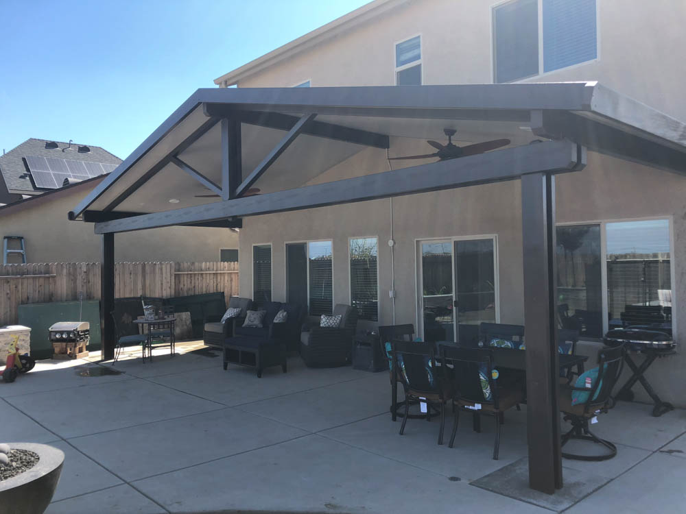 arched solid patio cover in backyard